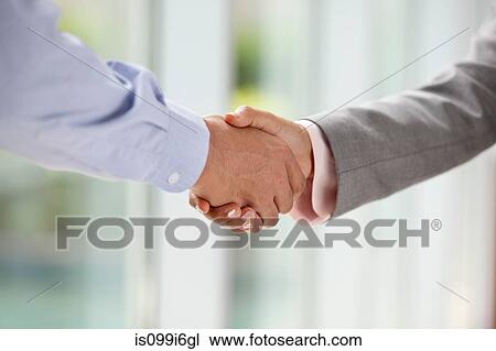 Stock Image - Close-up of hands shaking. Fotosearch