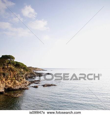 Coast and rocks tumbling into the sea, Costa Brava, Spain View Large Photo Image Stock Photo - Coast and rocks tumbling into the sea, Costa Brava, Spain. Fotosearch