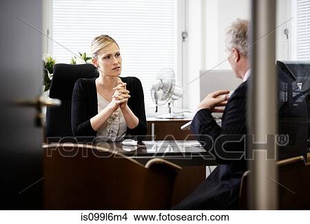 Picture - Colleagues talking in office. Fotosearch