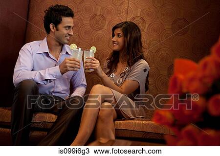 Couple having drinks in a restaurant View Large Photo Image Stock Image - Couple having drinks in a restaurant. Fotosearch