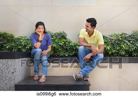 Couple sitting outside View Large Photo Image Stock Photograph - Couple sitting outside. Fotosearch