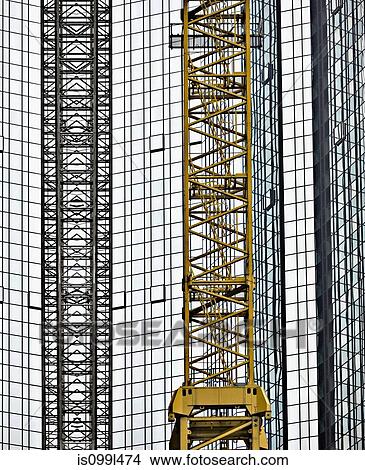 Crane in front of office building View Large Photo Image Picture - Crane in front of office building. Fotosearch