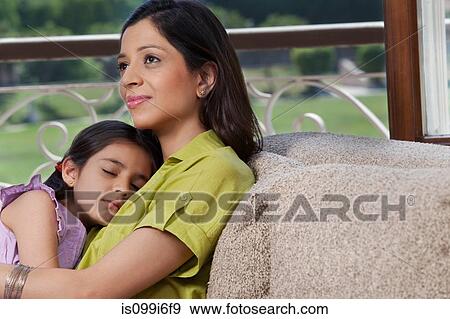 Stock Photo - Daughter sleeping on her mothers chest. Fotosearch