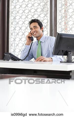 Stock Image - Executive talking on a phone. Fotosearch