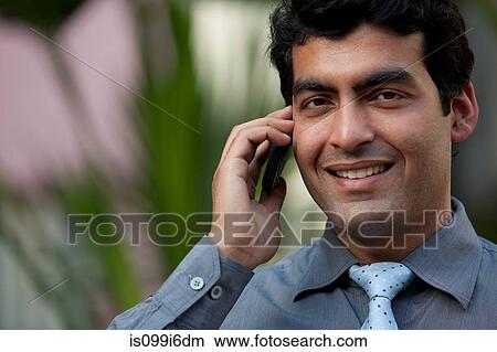 Executive with a mobile phone View Large Photo Image Picture - Executive with a mobile phone. Fotosearch