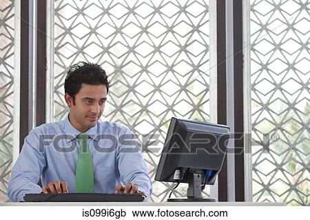 Executive working on a computer View Large Photo Image Stock Image - Executive working on a computer. Fotosearch