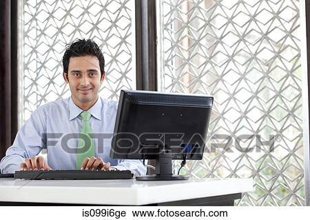 Executive working on a computer View Large Photo Image Stock Image - Executive working on a computer. Fotosearch