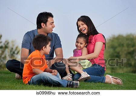 Family having fun in a park View Large Photo Image Stock Photograph - Family having fun in a park. Fotosearch