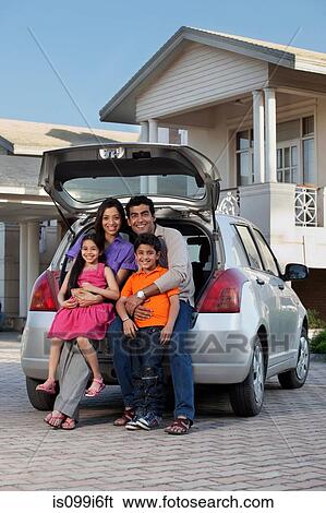 Family sitting at the back of a car View Large Photo Image Stock Photograph - Family sitting at the back of a car. Fotosearch