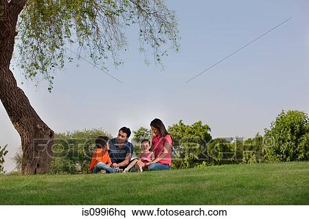 Stock Photography - Family sitting in a park. Fotosearch