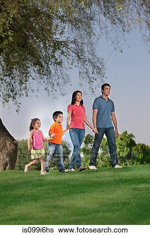 Family walking in a park View Large Photo Image Stock Photograph - Family walking in a park. Fotosearch