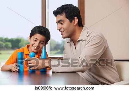 Father and son playing with building blocks View Large Photo Image Stock Image - Father and son playing with building blocks. Fotosearch