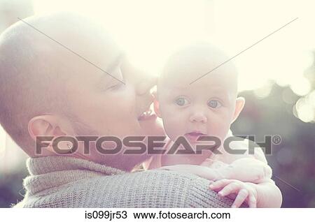 Stock Image - Father whispering to baby. Fotosearch