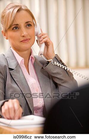 Female executive talking on the phone View Large Photo Image Stock Photo - Female executive talking on the phone. Fotosearch