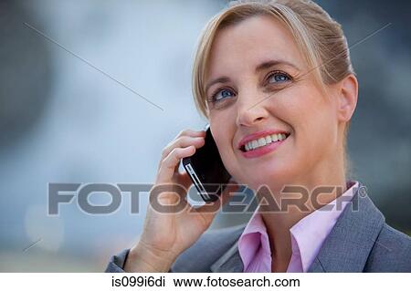 Female executive with a mobile phone View Large Photo Image Stock Image - Female executive with a mobile phone. Fotosearch
