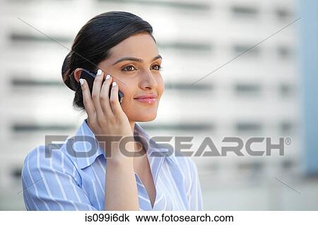 Stock Image - Female executive with a mobile phone. Fotosearch