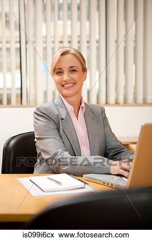 Stock Photo - Female executive working on a laptop. Fotosearch