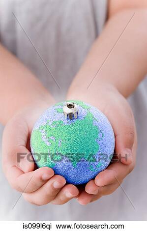 Girl holding globe decoration View Large Photo Image Stock Image - Girl holding globe decoration. Fotosearch