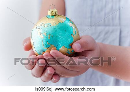 Girl holding globe decoration View Large Photo Image Stock Image - Girl holding globe decoration. Fotosearch