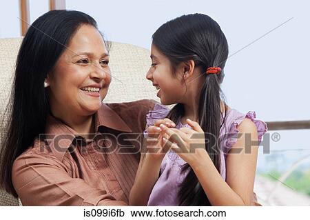 Girl sitting with her grandmother View Large Photo Image Stock Image - Girl sitting with her grandmother. Fotosearch