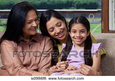 Girl with mother and grandmother on sofa View Large Photo Image Stock Photograph - Girl with mother and grandmother on sofa. Fotosearch