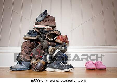 Large pile of boy's shoes beside one pair of girl's shoes View Large Photo Image Stock Photo - Large pile of boy's shoes beside one pair of girl's shoes. Fotosearch