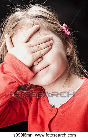 Little girl covering her eyes View Large Photo Image Picture - Little girl covering her eyes. Fotosearch