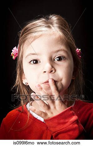 Little girl with finger on lips View Large Photo Image Picture - Little girl with finger on lips. Fotosearch