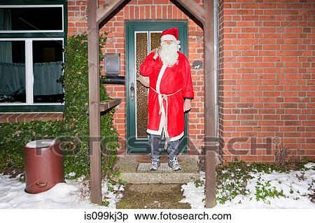 Man dressed as Santa Claus outside house View Large Photo Image Stock Photography - Man dressed as Santa Claus outside house. Fotosearch