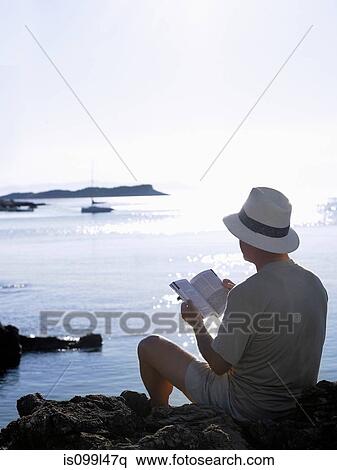 Man reading book by the ocean, Dubrovnik, Croatia View Large Photo Image Stock Photography - Man reading book by the ocean, Dubrovnik, Croatia. Fotosearch