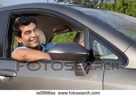 Man sitting in his car View Large Photo Image Stock Photograph - Man sitting in his car. Fotosearch