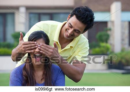 Stock Photograph - Man surprising his girlfriend. Fotosearch