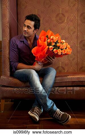 Stock Photo - Man with a bouquet of flowers. Fotosearch