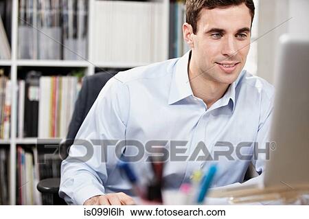Stock Image - Man working in office. Fotosearch