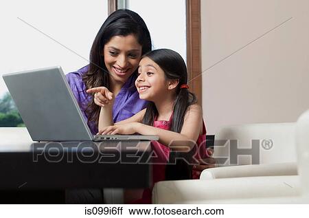 Mother and daughter having fun on a laptop View Large Photo Image Stock Image - Mother and daughter having fun on a laptop. Fotosearch