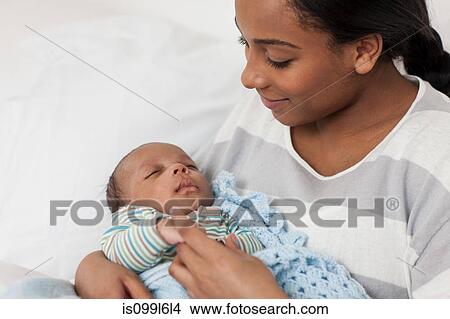 Mother holding baby son View Large Photo Image Picture - Mother holding baby son. Fotosearch