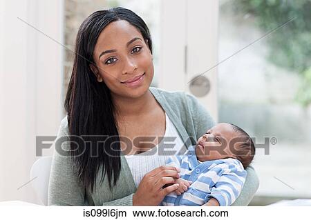 Mother holding her baby boy View Large Photo Image Picture - Mother holding her baby boy. Fotosearch