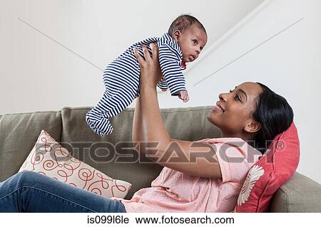 Mother lifting baby boy View Large Photo Image Stock Image - Mother lifting baby boy. Fotosearch