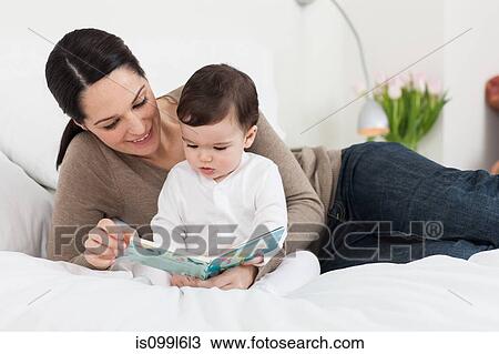 Mother reading a book with son View Large Photo Image Stock Image - Mother reading a book with son. Fotosearch