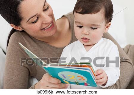 Stock Photography - Mother reading with baby son. Fotosearch