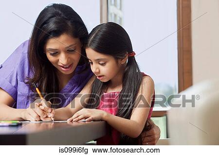 Mother teaching her daughter to write View Large Photo Image Stock Image - Mother teaching her daughter to write. Fotosearch