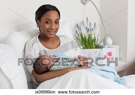 New mother with baby son View Large Photo Image Picture - New mother with baby son. Fotosearch