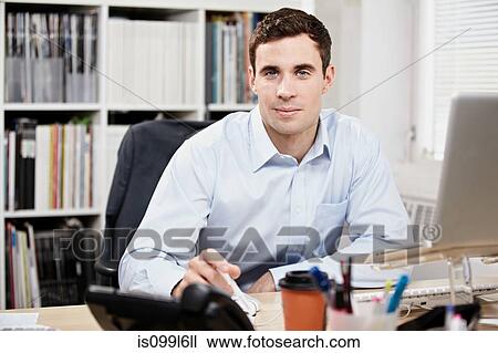 Stock Image - Office worker at his desk. Fotosearch