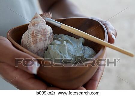 Person holding bowl of mud face mask and shell at spa View Large Photo Image Stock Photography - Person holding bowl of mud face mask and shell at spa. Fotosearch