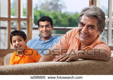 Stock Photography - Portrait of a family on a sofa. Fotosearch