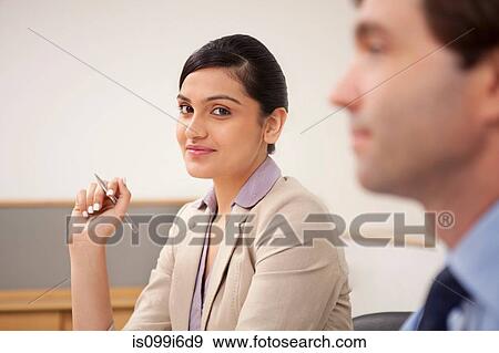 Stock Photo - Portrait of a female executive in a meeting. Fotosearch