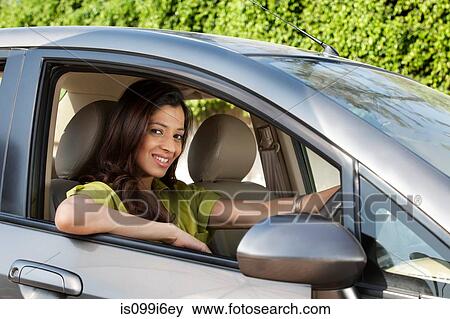 Portrait of a woman in a car View Large Photo Image Stock Photo - Portrait of a woman in a car. Fotosearch
