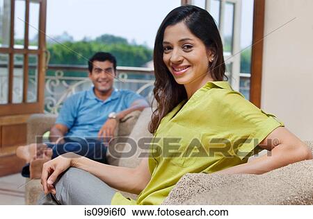 Stock Image - Portrait of a woman on a sofa. Fotosearch