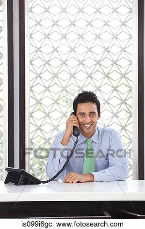 Portrait of executive talking on a phone View Large Photo Image Stock Image - Portrait of executive talking on a phone. Fotosearch