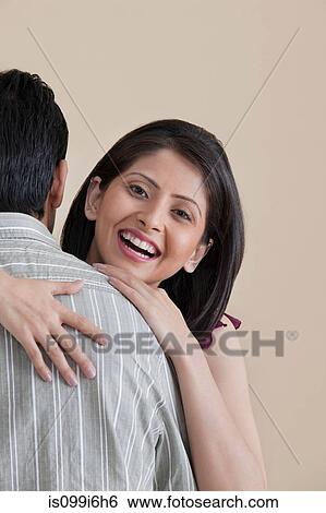 Portrait of woman hugging her husband View Large Photo Image Stock Photograph - Portrait of woman hugging her husband. Fotosearch